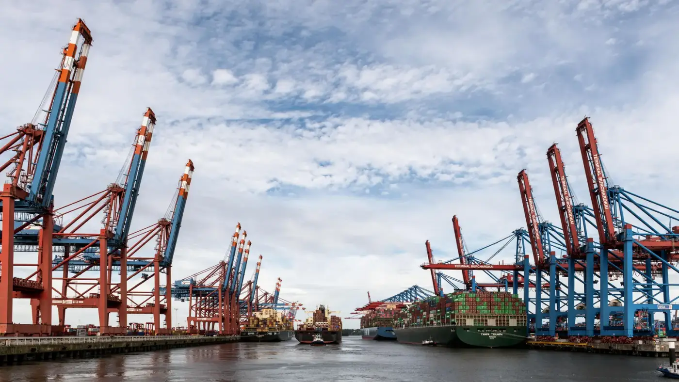 Container ship being worked by gantry cranes at a port terminal